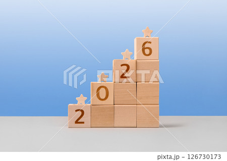 Wooden cubes with with numbers 2026 and wooden stars are a symbol of success, business progress, strategic development of a company, startup. Business concept Wooden cubes with with numbers 2026 and wooden stars are a symbol of success, business progress, strategic development of a company, startup. Business concept 126730173