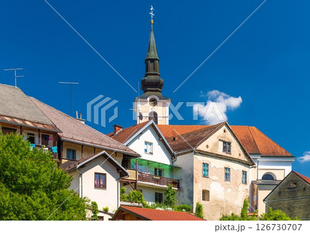 View of old residential houses in front of the Parish Church of St. Nicholas in Metlika, Slovenia 126730707