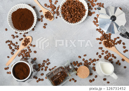 Coffee beans, ground coffee, and brewing tools arranged on a textured surface, creating an inviting atmosphere for coffee lovers and enthusiasts Coffee beans, ground coffee, and brewing tools arranged on a textured surface, creating an inviting atmosphere for coffee lovers and enthusiasts 126731452