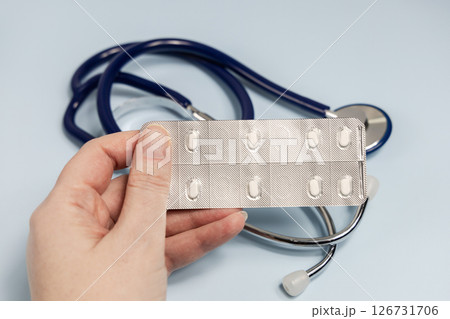 Female hands holding pills in blister. Prescription medication Female hands holding pills in blister. Prescription medication 126731706