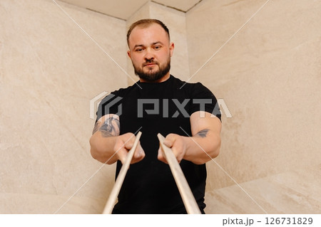 Construction worker installing ceramic tiles on bathroom wall using level tool 126731829