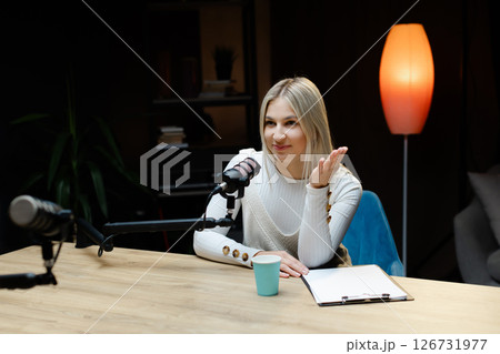 Smiling woman recording podcast in home studio 126731977