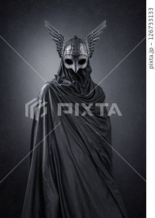 Warrior spirit with winged helmet over dark misty background Warrior spirit with winged helmet over dark misty background 126733133