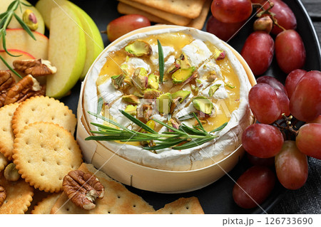 Baked Camembert with honey, pistachios, top view 126733690