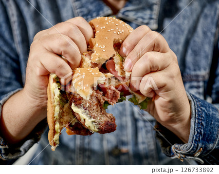 broken burger in human hands 126733892