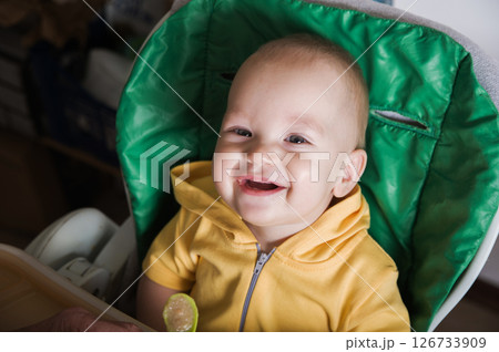 Happy Baby Being Fed by Grandmother at Home Happy Baby Being Fed by Grandmother at Home 126733909
