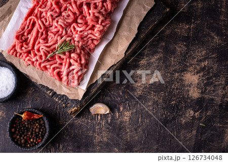 Raw minced meat on dark background 126734048