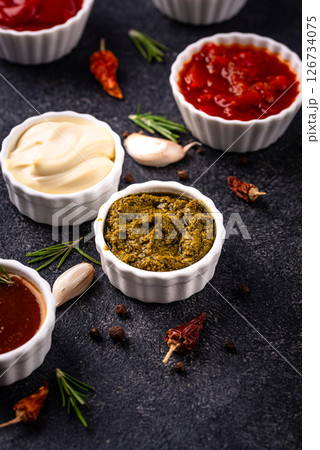 Set of different sauces. Ketchup, mustard, pesto Set of different sauces. Ketchup, mustard, pesto 126734075