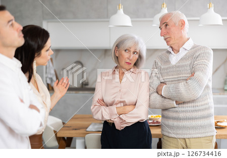 Young girl introducing her boyfriend to her discontented parents at home 126734416