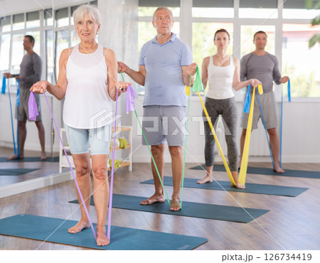 Elderly woman exercises with pilates band 126734419