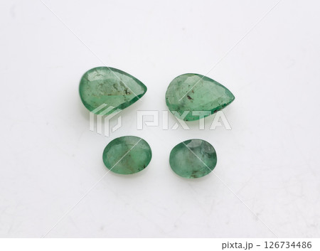 Natural Emerald Gemstones Collection Featuring Two Pear-Cut and Two Round-Cut Untreated Loose Emeralds Displayed on a White Surface, Vivid Green Color, Jewelry Making Natural Emerald Gemstones Collection Featuring Two Pear-Cut and Two Round-Cut Untreated Loose Emeralds Displayed on a White Surface, Vivid Green Color, Jewelry Making 126734486