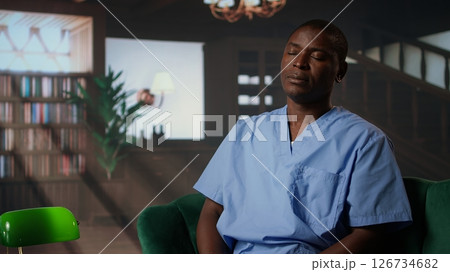 Psychotherapist assists man nurse to deal with patients complications, therapy and psychological support within a healthcare career. Emotional stress and PTSD in a counseling session. Camera A. Psychotherapist assists man nurse to deal with patients complications, therapy and psychological support within a healthcare career. Emotional stress and PTSD in a counseling session. Camera A. 126734682