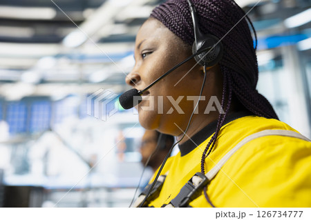 Helpline worker troubleshooting errors in solar production systems using headset, woman providing support for photovoltaic malfunctions or technical issues in renewable energy plant. Helpline worker troubleshooting errors in solar production systems using headset, woman providing support for photovoltaic malfunctions or technical issues in renewable energy plant. 126734777