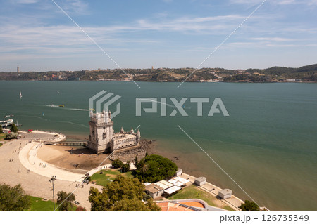 Belem Tower on Tagus River with boats creating Belem Tower on Tagus River with boats creating 126735349