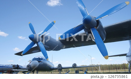 Vintage Aircraft With Blue Propellers Displayed Outdoors Against a Clear Sky at an Aviation Museum on a Sunny Day Vintage Aircraft With Blue Propellers Displayed Outdoors Against a Clear Sky at an Aviation Museum on a Sunny Day 126735861