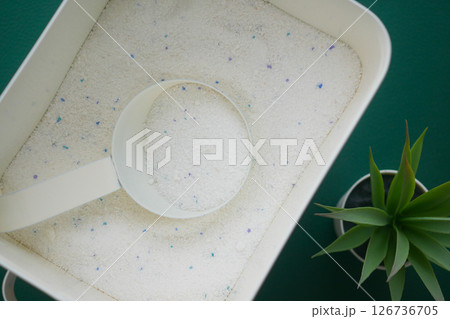Laundry detergent in a container with a measuring scoop Laundry detergent in a container with a measuring scoop 126736705