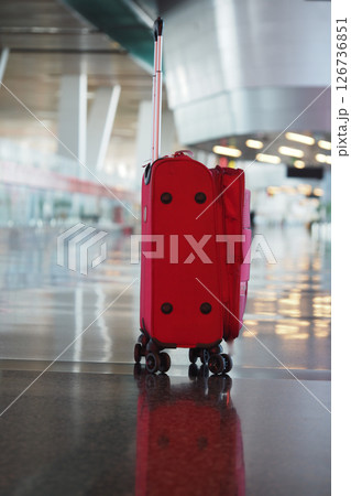 Travel bag waits at airport terminal during quiet hours 126736851