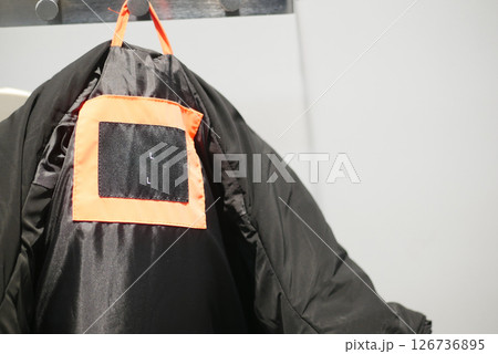 Warm black jacket hanging in a retail store 126736895