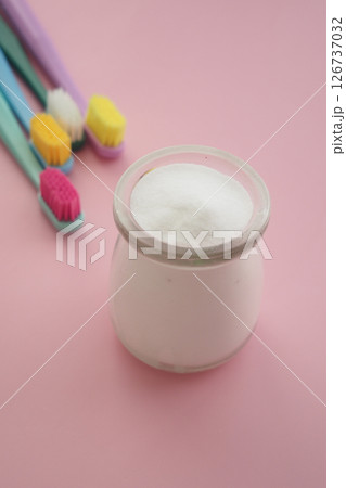 baking soda and tooth brush on pink background  126737032