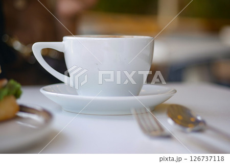 Ceramic cup on a white table at morning cafe Ceramic cup on a white table at morning cafe 126737118
