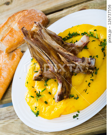 Tasty pinnekjott, lamb rib with mashed potato and greens, served at plate Tasty pinnekjott, lamb rib with mashed potato and greens, served at plate 126737556