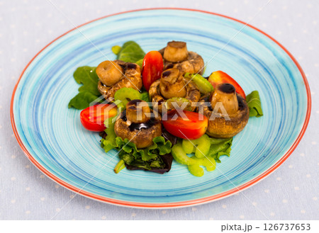 Baked champignons with spinach, lettuce, tomatoes, celery 126737653