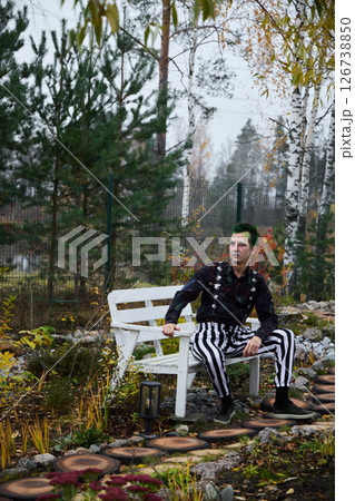 A Contemporary Fashion Portrait Set Against a Serene and Tranquil Garden Environment 126738850