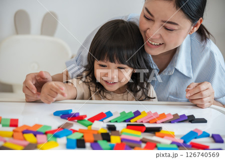toddler girl and mother playing colorful wooden block toy or domino game together 126740569