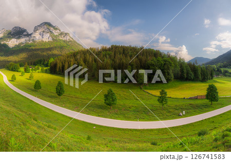 Meadow with road and bench during sunset in Berchtesgaden National Park Meadow with road and bench during sunset in Berchtesgaden National Park 126741583