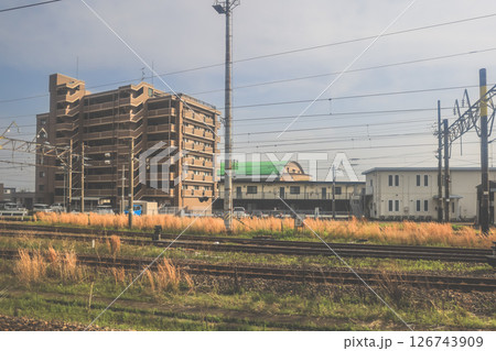 March 28 2025 Wide Agricultural Fields near Industrial Buildings with Mountains March 28 2025 Wide Agricultural Fields near Industrial Buildings with Mountains 126743909