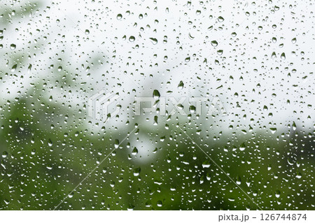 Raindrops scatter across a clear windowpane, macro photo Raindrops scatter across a clear windowpane, macro photo 126744874