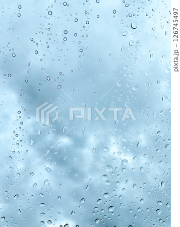 Raindrops on Window with Moody Cloudy Sky 126745497