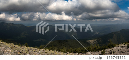 A sweeping view of rolling mountain ranges under a cloud-filled sky. A sweeping view of rolling mountain ranges under a cloud-filled sky. 126745521