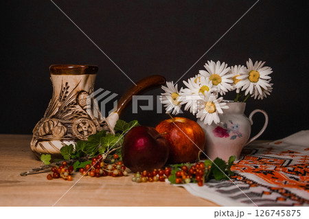 a pitcher of chamomile and an apple a pitcher of chamomile and an apple 126745875