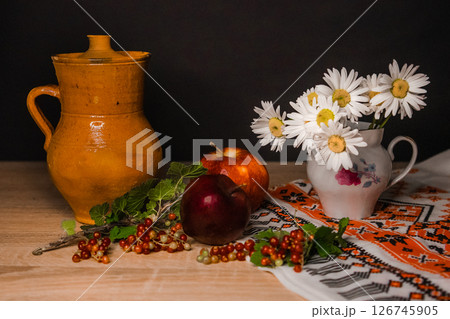 a pitcher of chamomile and an apple a pitcher of chamomile and an apple 126745905