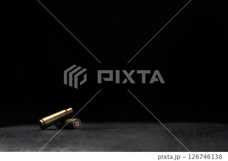 Minimalistic composition emphasizing military and dramatic elements with a focus on weaponry. 126746138