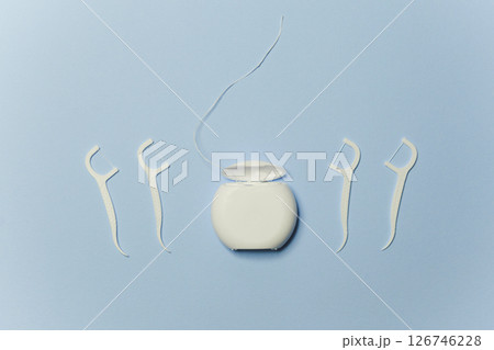 Pack in Coil and Dental floss with handle on blue background, flat lay. Dental care. 126746228