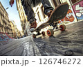 Skilled maneuver. Man rides longboard in squat position, bottom view. 126746272