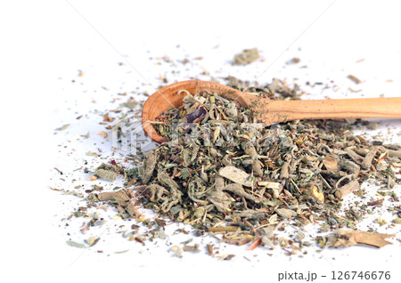 Dry green tea in wooden spoon on white background. Mix of healing herbs. Beverages, organic product and health. 126746676