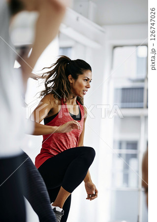Group Fitness Class in Motion at a Bright Gym With Engaged Participants Group Fitness Class in Motion at a Bright Gym With Engaged Participants 126747026