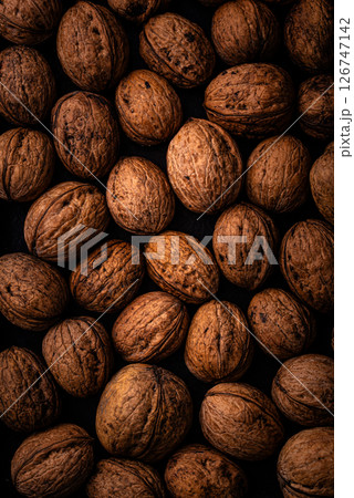Walnuts background with black and brown colors 126747142