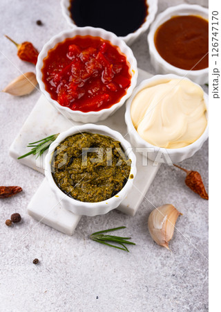 Set of different sauces. Ketchup, mustard, pesto 126747170