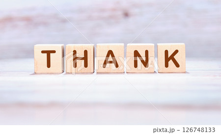 Appreciation concepts. Text THANK written on wooden cubes on a delicate pastel background 126748133