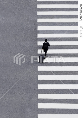 Man with luggage walking Crosswalk City street Business people lifestyle High angle view 126748320