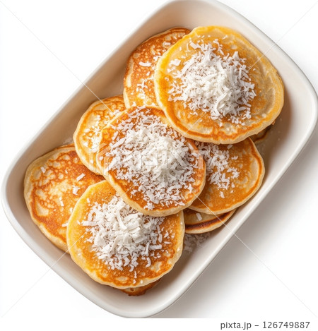 Warm Thai Coconut Pancakes Topped with Shredded Coconut in Dish Warm Thai Coconut Pancakes Topped with Shredded Coconut in Dish 126749887