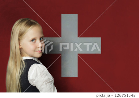 Happy young child girl on flag of Switzerland background. Education and study language concept 126751348