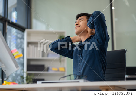 Male businessman is doing a stretchy posture due to sitting in the office for too long, office syndrome concept. 126752372