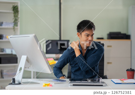 Male businessman is doing a stretchy posture due to sitting in the office for too long, office syndrome concept. Male businessman is doing a stretchy posture due to sitting in the office for too long, office syndrome concept. 126752381