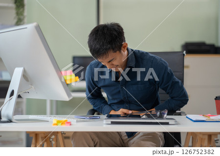Diarrhea or constipation, problems with health concept. Closeup man sitting at table in office feeling pain in stomach touching it with hands having Abdomen disease and illness. Diarrhea or constipation, problems with health concept. Closeup man sitting at table in office feeling pain in stomach touching it with hands having Abdomen disease and illness. 126752382