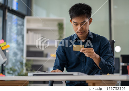 Businessman calculating monthly office expenses, taxes, bank account balance and credit card bills payment. Businessman calculating monthly office expenses, taxes, bank account balance and credit card bills payment. 126752393